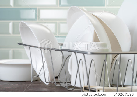 Dish rack with clean dry dishes on kitchen counter Dish rack with clean dry dishes on kitchen counter 140267186
