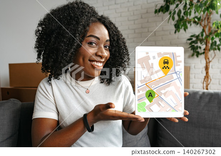 Map showing taxi route with a woman holding a tablet indoors during the day Map showing taxi route with a woman holding a tablet indoors during the day 140267302
