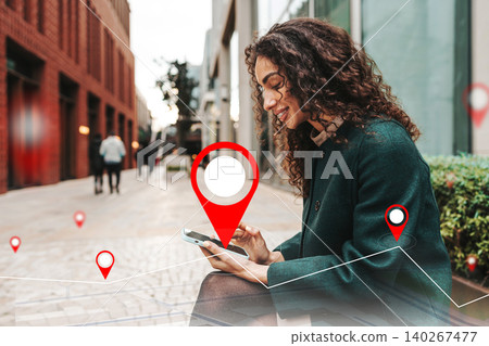 Woman using smartphone to check taxi route on a map in a city street 140267477