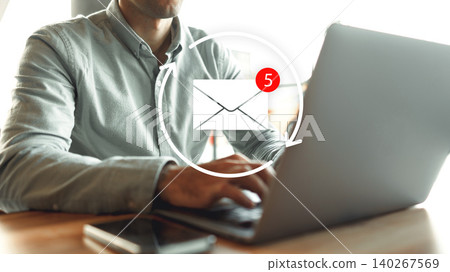 Person checks email on laptop while sitting at a table indoors during the day Person checks email on laptop while sitting at a table indoors during the day 140267569