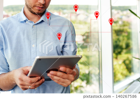 Man uses tablet to plan taxi route on map for travel within a city 140267586