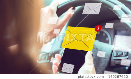Driving while checking messages on a phone can be risky and dangerous for drivers Driving while checking messages on a phone can be risky and dangerous for drivers 140267620
