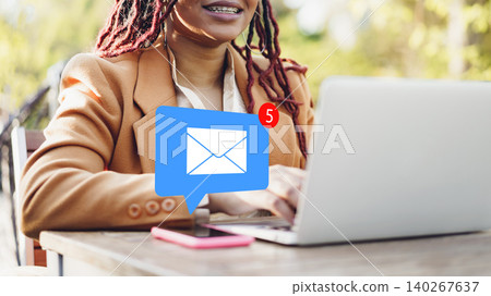 Woman using laptop to check emails in a cafe during daytime Woman using laptop to check emails in a cafe during daytime 140267637