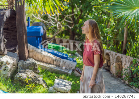 Woman tourist visiting traditional Mexican cemetery for Day of the Dead, exploring colorful graves, cultural heritage and Dia de los Muertos travel concept Woman tourist visiting traditional Mexican cemetery for Day of the Dead, exploring colorful graves, cultural heritage and Dia de los Muertos travel concept 140267745