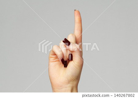 Hand shows a single finger pointing up in a clear background during a quiet moment 140267802