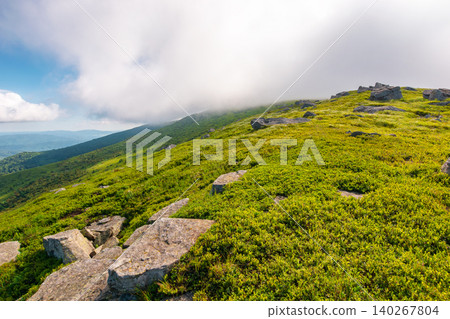 nature scenery with mountain under summer sky. alpine landscape of carpathian mountain with grassy slopes. low fluffy clouds on high altitude. summer vacations nature scenery with mountain under summer sky. alpine landscape of carpathian mountain with grassy slopes. low fluffy clouds on high altitude. summer vacations 140267804