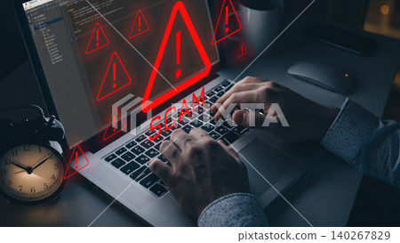Warning about a scam message on a laptop with alarming symbols at night Warning about a scam message on a laptop with alarming symbols at night 140267829