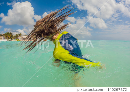 Teen boy swimming alone in turquoise Caribbean sea, enjoying tropical water, sunny beach vacation, active childhood and summer travel concept Teen boy swimming alone in turquoise Caribbean sea, enjoying tropical water, sunny beach vacation, active childhood and summer travel concept 140267872