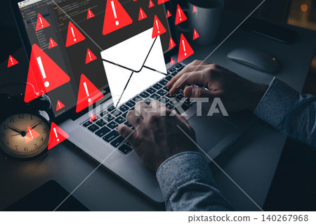 Scam message alert on computer screen with hands typing at night 140267968