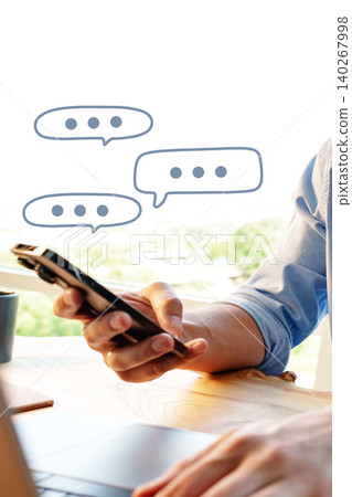 Person using phone to send messages in a bright indoor space during the day Person using phone to send messages in a bright indoor space during the day 140267998