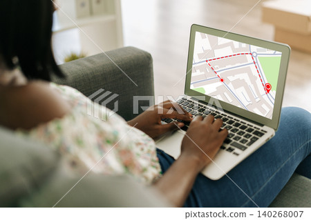 User checks a map on laptop to find a taxi location in a city area during daytime User checks a map on laptop to find a taxi location in a city area during daytime 140268007