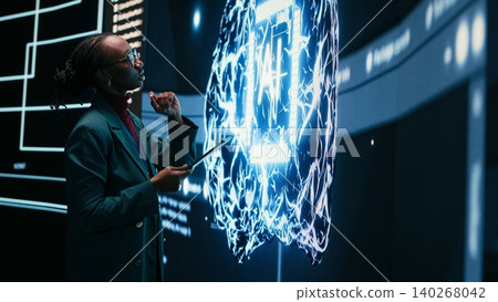 Technician implements digital guardrails on autonomous AI system using tablet to limit risk. African american woman applies artificial intelligence safety constraints with device Technician implements digital guardrails on autonomous AI system using tablet to limit risk. African american woman applies artificial intelligence safety constraints with device 140268042