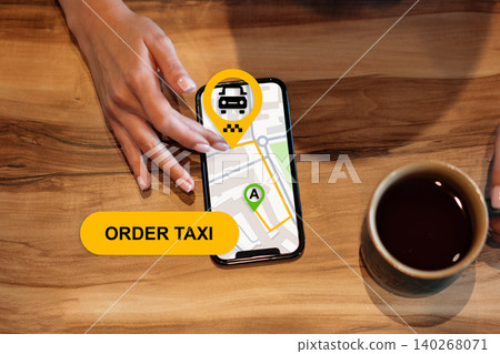 Finding a taxi location on a travel app while enjoying coffee at a table 140268071