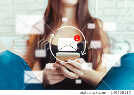 Checking messages on a smartphone while sitting at home in the afternoon Checking messages on a smartphone while sitting at home in the afternoon 140268117