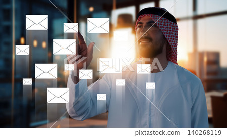 Man interacts with digital messages in an office setting during early morning hours Man interacts with digital messages in an office setting during early morning hours 140268119