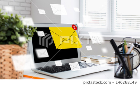Notifications appear on a laptop screen showing new messages in a workspace setup Notifications appear on a laptop screen showing new messages in a workspace setup 140268149