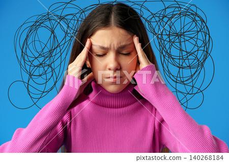 Young person experiences stress while thinking about many thoughts on blue background Young person experiences stress while thinking about many thoughts on blue background 140268184