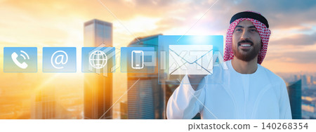Man using digital communication icons in a city setting during sunset Man using digital communication icons in a city setting during sunset 140268354