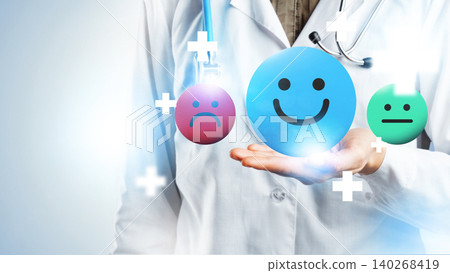 Health professional holds symbols of emotions in hand during therapy session with patients Health professional holds symbols of emotions in hand during therapy session with patients 140268419