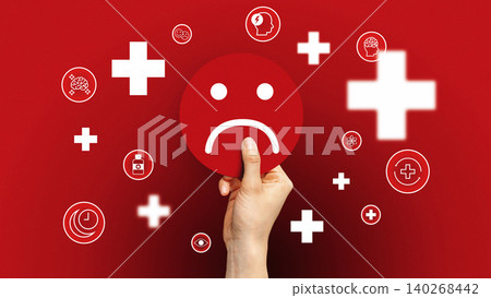 Hand holding sad face symbol with health icons on red background in a bold design 140268442