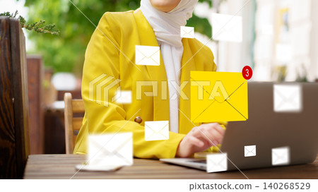 Person checks emails on laptop outside with notification of new messages showing Person checks emails on laptop outside with notification of new messages showing 140268529