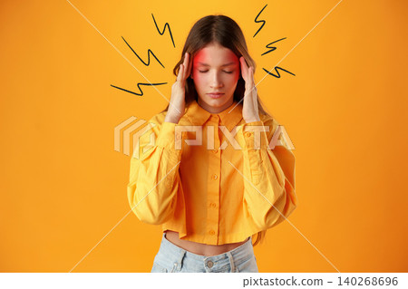 Young person holding head to show discomfort against bright background Young person holding head to show discomfort against bright background 140268696