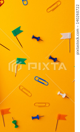 Colorful stationery items scattered on a bright yellow surface during daylight hours Colorful stationery items scattered on a bright yellow surface during daylight hours 140268722