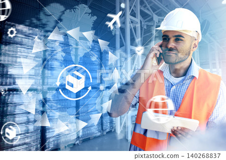 Logistics worker talks on phone at warehouse while planning delivery operations Logistics worker talks on phone at warehouse while planning delivery operations 140268837