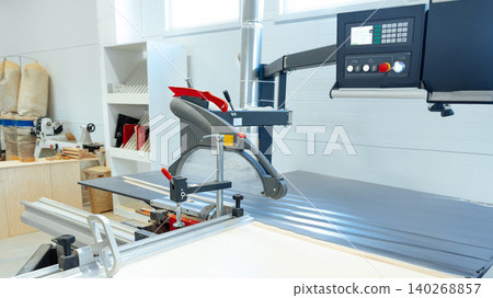 Woodworking equipment in use at a workshop during daytime hours Woodworking equipment in use at a workshop during daytime hours 140268857