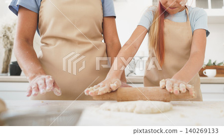 Baking cookies with family in a kitchen during the afternoon while preparing dough Baking cookies with family in a kitchen during the afternoon while preparing dough 140269133