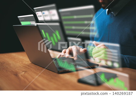 Business person uses laptop to analyze digital data and charts in office setting Business person uses laptop to analyze digital data and charts in office setting 140269187