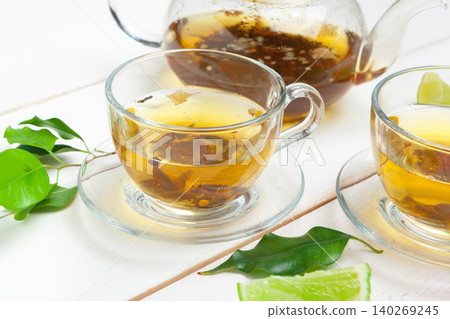 teapot and cups of tea on a white wooden background teapot and cups of tea on a white wooden background 140269245
