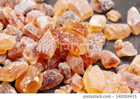 brown sugar rock organic crystalline close up on dark background brown sugar rock organic crystalline close up on dark background 140269415