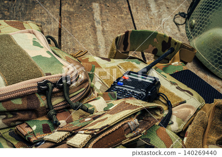 Military body armor on wooden background close up Military body armor on wooden background close up 140269440