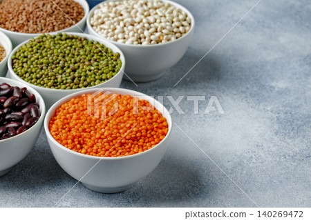 White ceramic bowls with assorted grains on kitchen table White ceramic bowls with assorted grains on kitchen table 140269472