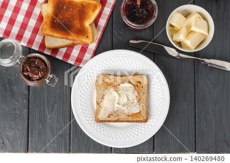 Simple breakfast. Toasted bread covered with butter Simple breakfast. Toasted bread covered with butter 140269480