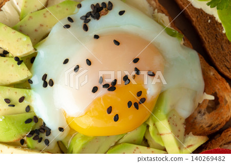 Sandwich with fried egg and avocado pieces Sandwich with fried egg and avocado pieces 140269482