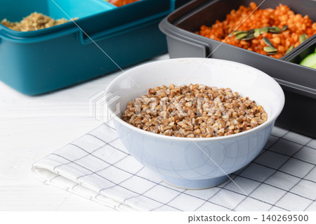 Lunch box with cooked buckwheat and fresh vegetable salad 140269500