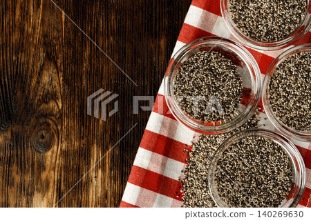 Glass bowl with chia seeds on wooden table 140269630