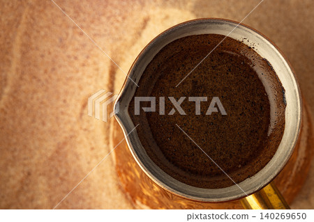 Copper turk with coffee brewing in sand Copper turk with coffee brewing in sand 140269650