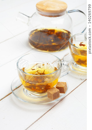 teapot and cups of tea on a white wooden background teapot and cups of tea on a white wooden background 140269799