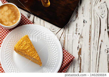 Slice of layered honey cake on plate Slice of layered honey cake on plate 140269884
