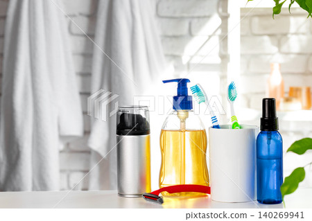 Cosmetic bottles against white bathroom wall background Cosmetic bottles against white bathroom wall background 140269941