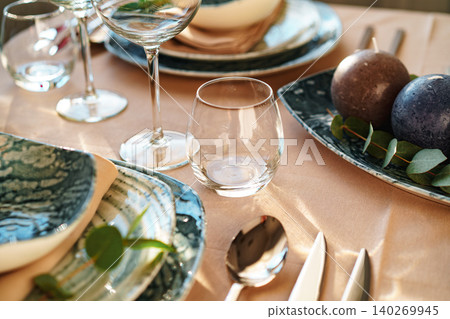 Beautiful elegant table setting with green stylish dishware and silver cutlery Beautiful elegant table setting with green stylish dishware and silver cutlery 140269945