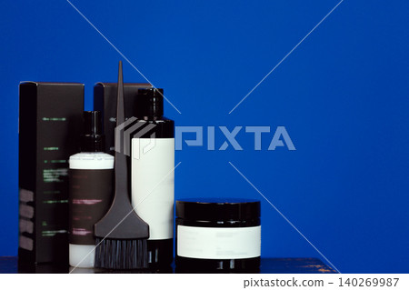 Hair coloring cosmetic products in black packages with copy space Hair coloring cosmetic products in black packages with copy space 140269987