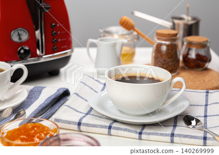 White cup of coffee on wooden kitchen table White cup of coffee on wooden kitchen table 140269999
