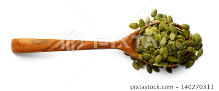 Wooden spoon with raw pumpkin seeds isolated on white Wooden spoon with raw pumpkin seeds isolated on white 140270311