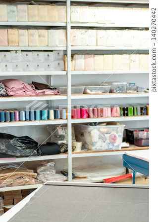 Craft workshop with shelves of supplies and materials used in various projects 140270442