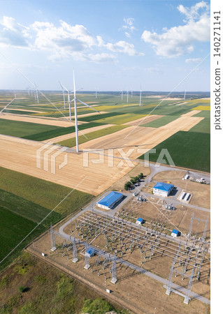 Aerial view of wind turbines with electric power station. 140271141