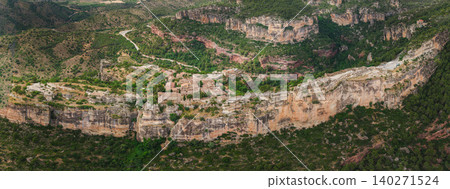 Detailed aerial view of Siurana village dramatically perched on a narrow sandstone cliff plateau in Catalonia, Spain. Detailed aerial view of Siurana village dramatically perched on a narrow sandstone cliff plateau in Catalonia, Spain. 140271524
